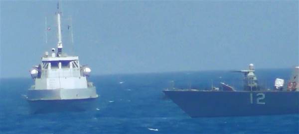 Image: Iranian vessel steers close to the U.S. Navy coastal patrol craft USS Thunderbolt in the Gulf i