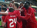 Liverpool players mob goal scorer Philippe Coutinho as they celebrate their sides first goal. 0-1