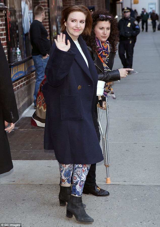 Conservative chic: The actress/writer was clad in a white blouse, patterned trousers, and a long navy coat