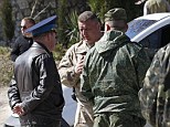 Stand off: A Russian military officer (back) talks to Colonel Yuli Mamchur (left) demanding Ukrainian servicemen to leave a military base in the Crimean town of Belbek near Sevastopol