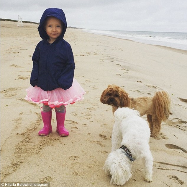 'She woke up from her nap saying, playa (beach)': On Tuesday, the flexible yogi posted a picture of their 22-month-old daughter Carmen enjoying a rainy day at the beach