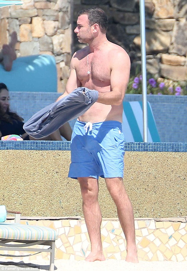 Pumped up: Naomi's hunky beau Liev Scheiber, 48,  stripped off his T-shirt to reveal his muscled chest and six-pack tummy