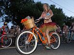 Cruising: Thousands of cyclists, most of them fully of partially nude, poured into the streets of Portland, Oregon on Saturday night for World Naked Bike Ride