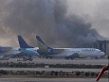 Smoke rises after militants launched an early morning assault at Jinnah International Airport in Karachi in Pakistan, killing at least 26 people