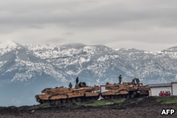 FILE - Turkish tanks are parked near the Syrian border at Hassa, in Hatay province, Jan. 24, 2018, as part of the Operation Olive Branch.