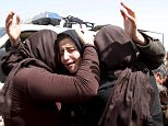 Members of the minority Yazidi sect who were freed by Islamic State militants hug each other on the outskirts of Kirkuk on April 8, 2015. More than 200 elderly and infirm Yazidis were freed on Wednesday by Islamic State militants who had been holding them captive since overruning their villages in northwestern Iraq last summer. REUTERS/Ako Rasheed  TPX IMAGES OF THE DAY