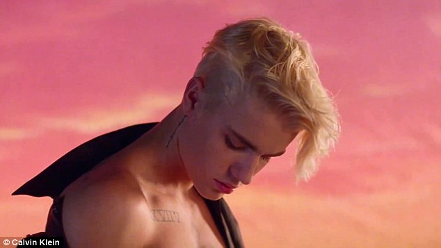 Any excuse: Bieber, 21, goes shirtless in the video clip which features numerous stars