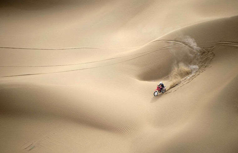 Wang Yirong of Hebei province rides his motorcycle in a desert during the China Taklimakan Rally and CCR Xinjiang Station, in Shanshan, Xinjiang Uighur Autonomous Region. (China Daily/via Reuters)