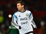 Argentina striker Lionel Messi (C) warms up ahead of the international friendly football match between the Argentina and Portugal at Old Trafford in Manchester on November 18, 2014. AFP PHOTO / PAUL ELLISPAUL ELLIS/AFP/Getty Images