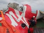 Indonesian officials examine the wreckage from AirAsia flight QZ8501 after it was lifted into the Crest Onyx ship in the Java Sea, on January 10, 2015