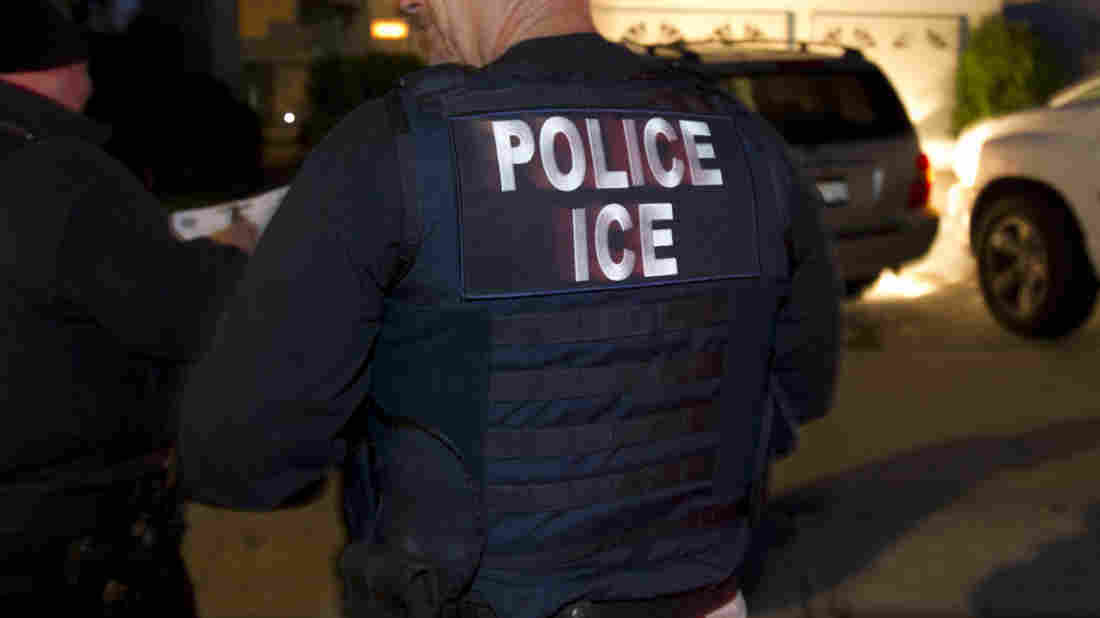 ICE agents wait outside of the home of a suspect in 2012 in San Diego.