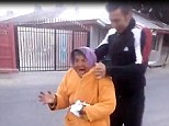 Terrified: An elderly Romanian woman screams as she is grabbed by a drunken yob who then swings her around in the street