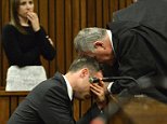 South African athlete Oscar Pistorius is comforted by his lawyer Barry Roux, while listening to a family witness's account of her longstanding friendship with Reeva Steenkamp, during his sentencing proceedings at the high court in Pretoria, on October 15, 2014. The Paralympian star athlete was found guilty last month of unlawfully killing his girlfriend Reeva Steenkamp but acquitted of the more serious charge of murder. Judge Thokozile Masipa is due to rule on his punishment, with her options ranging from a fine to 15 years in prison. AFP PHOTO / POOL / ANTOINE DE RASAntoine de Ras/AFP/Getty Images