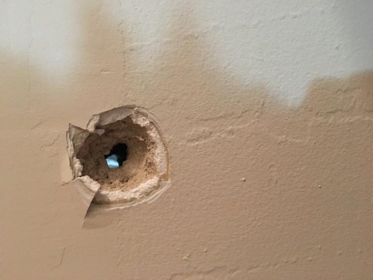 A bullet hole is shown after a police shooting  at 1370 Newkirk Ave. in Brooklyn.