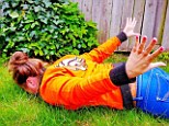 Persieing: A Holland fan donning her orange colours copies Robin van Persie's flying header