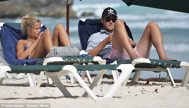 Beach babe: As she soaked up the sun with her sports star boyfriend, the 27-year-old looked incredible in a mismatching two-piece bikini