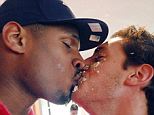 Celebration: Michael Sam and boyfriend Vito Cammisano kiss after Sam smashed cake into his face