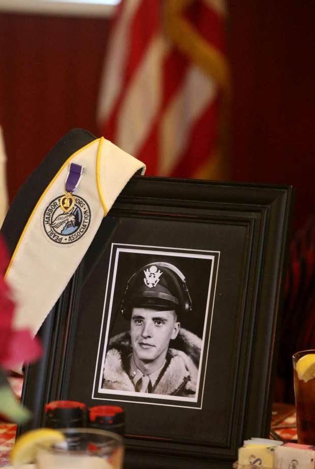 Sandra Anderson Mathis (right) bows her head in silence Thursday December 7, 2017 at a lunch held at the Barn Door restaurant in honor of Pearl Harbor survivors. Mathis' father (pictured) was Richard Anderson who survived the attack on Pearl Harbor and later in the war became a B-24 bomber pilot. Richard Anderson passed away last October. Pearl Harbor was attacked by the Japanese December 7, 1941. Photo: John Davenport, STAFF / San Antonio Express-News / John Davenport/San Antonio Express-News