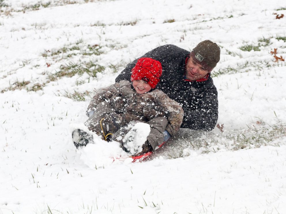 Allen and Cooper Alexander, 4, spin around while sledding down a hill Friday Dec. 8, 2017, in Vicksburg, Miss. Heavy snow fell across several Southern states Friday. (Courtland Wells/The Vicksburg Post via AP)