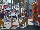 In agony: The unidentified man is loaded into the ambulance following the attack