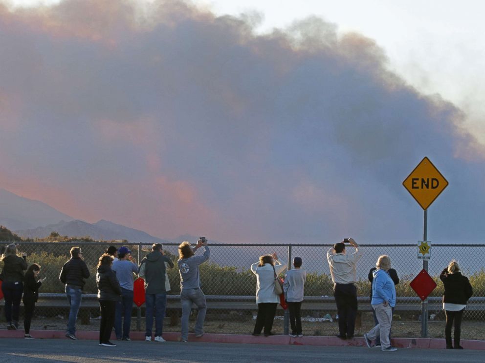 PHOTO: People gather on Poe Parkway in Stevenson Ranch to watch the fire fighting efforts on the Rye fire, Santa Clarita, Calif. Dec.5, 2017. 