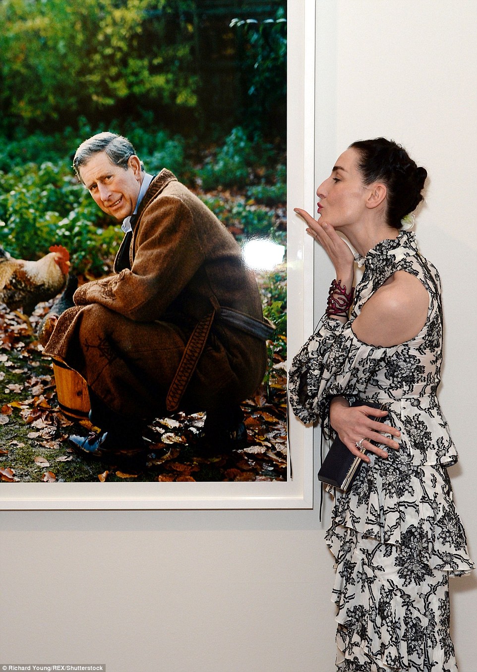 Kissing a prince: Erin blew a kiss at one photo of Prince Charles at his country estate which had made the exhibition