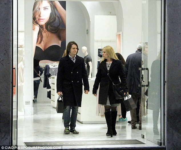  Raffaele Sollecito is pictured with a companion leaving a clothes shop in the Italian capital, Rome