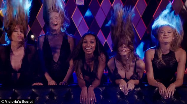 Clearly having fun, the girls all flip their hair over in unison and start to giggle