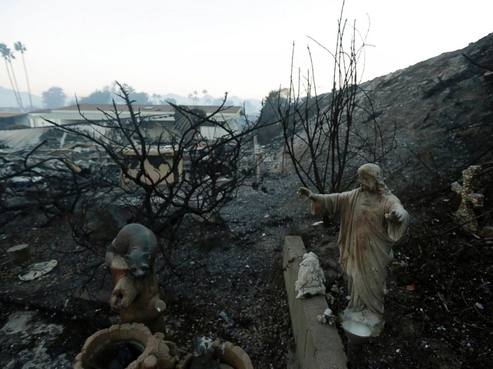 A statue sits among destroyed homes in the Rancho Monserate Country Club community Friday, Dec. 8, 2017, in Fallbrook, Calif. The wind-swept blazes have forced tens of thousands of evacuations and destroyed dozens of homes in Southern California. (AP