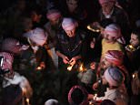 In this Tuesday, April 15, 2015 photo, Yazidis gather at the holy shrine of Lalish, 57 kilometers (35 miles) north of militant-held Mosul, Iraq, as thousands gather to mark the New Year, their first since Islamic State militants swept through the area last summer. Yazidis, a centuries-old religion derived from Zoroastrianism, Christianity and Islam, believe that the occasion marks the creation of the earth, also the day that God created the holy shrine in Lalish. (AP Photo/Seivan M. Salim)