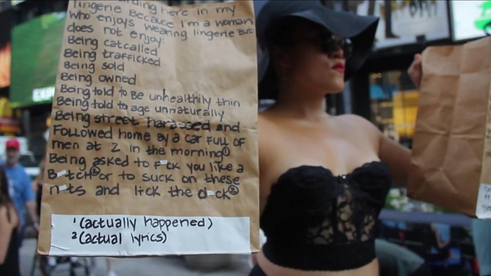 Oh wears only lingerie in the middle of Times Square as part of a project that supports allowing women to dress in a sexualized way and not fear catcalls or other harassment.