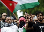 Pro-Palestinian demonstrators take to the streets of Paris on Sunday. France's socialist government has sparked uproar after it banned protests against Israeli action in Palestine