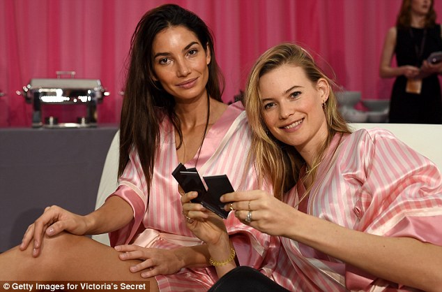 They're used to it: Behati, whose first show was in 2007, cuddled up to another veteran Angel, Lily Aldridge, backstage