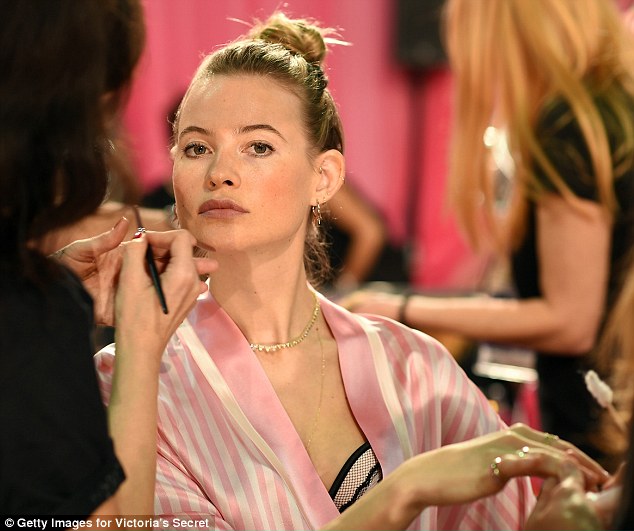 Poised to perfection: Behati kept still as make-up was applied to her lips and varnish to her nails