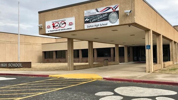 In this Feb. 24, 2018 photo, the main entrance of Dalton High School is shown, in Dalton, Ga. Police in Georgia say officers are responding to reports of shots fired at the high school and a teacher who may have been barricaded in a classroom is in custody. (AP Photo/Jeff Martin)