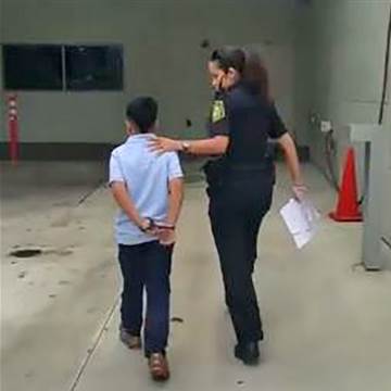 Image: 7-year-old in handcuffs