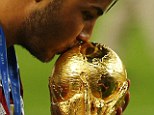 The world in his grasp: The Bayern Munich midfielder kisses the trophy