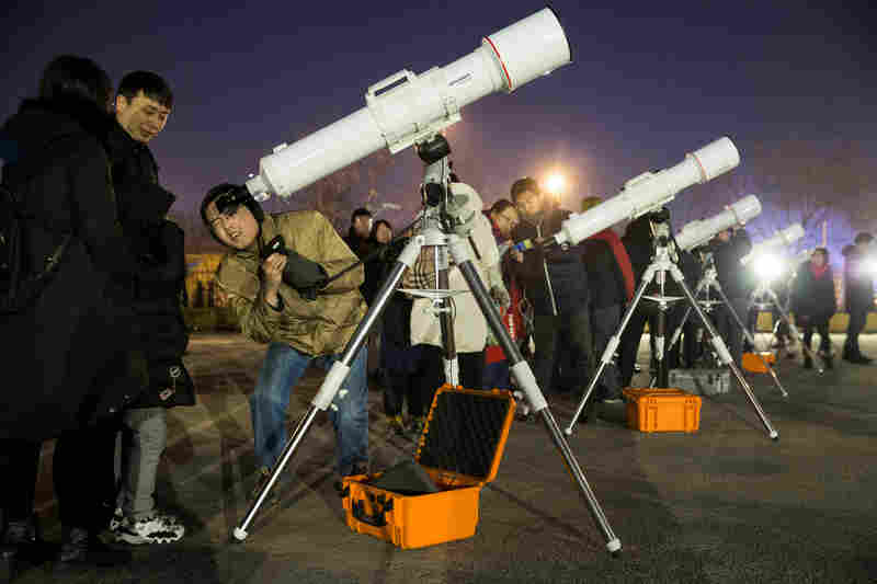 Skywatchers in China gather at Beijing Planetarium to watch a super blue blood moon eclipse with telescopes.