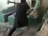 Forceful: The rebels, who are members of the Islamic State terror group, were filmed attacking centuries-old graves in the north-west city of Mosul in Ninevah province