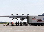 Journey: The first bodies of those killed in the MH17 massacre have been loaded onto a cargo plane ready to be transported to Eindhoven in the Netherlands for a tortuous identification process that could take months