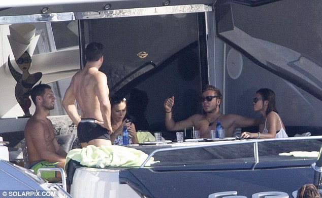 Chilled: Mario Gotze relaxes with his lingerie model girlfriend Ann-Kathrin Brommel and friends on a boat