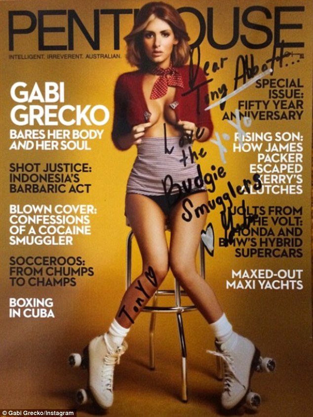 'Love the Budgie Smugglers'! The covergirl signs one of her covers to Prime Minister Tony Abbott