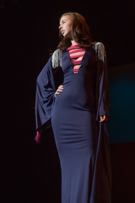 Junior business administrations major, Kelsey Peirson poses on stage during the Confluence fashion show Thursday night. (Photo credit: Austin Simpson)