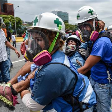 Image: An opposition demonstrator wounded during clashes with riot police in Venezuelan 