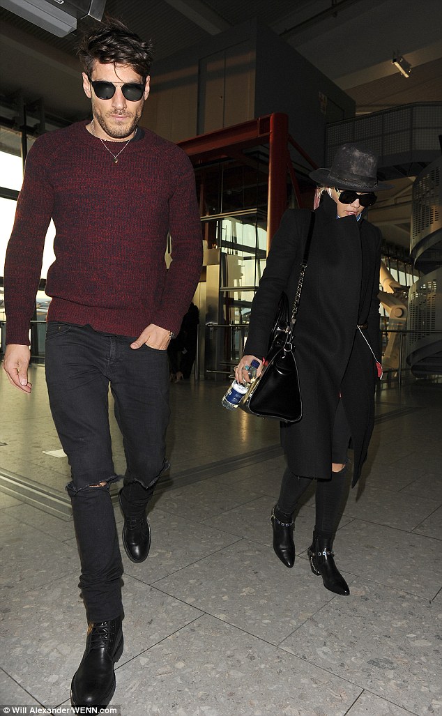 Fashionable friends: Chris, meanwhile, cut a dapper figure in a fitted maroon jumper and skinny black jeans, also opting to wear a pair of sunglasses on the journey 