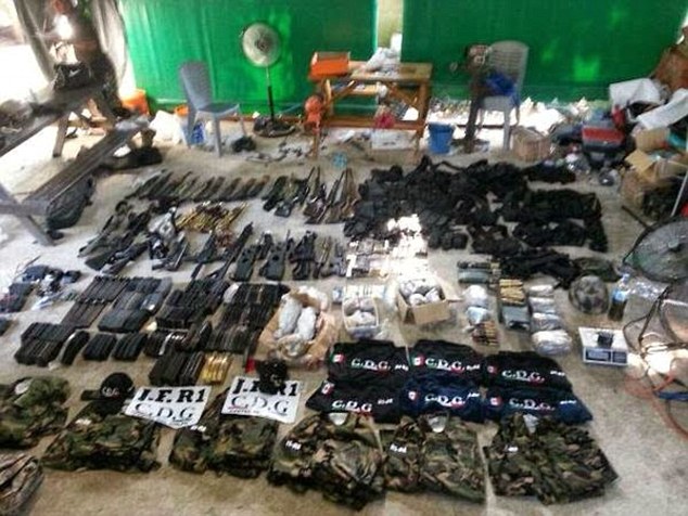 Pictured is a haul of weapons seized by authorities during a raid in the city of Altamira in April last year. Among the haul, which bears the logo of the Gulf Cartel, are mines, grenade launchers, grenades and assault rifles