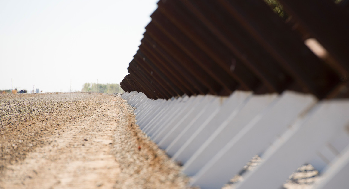 Cross bars make up the border fence along the Colorado River that acts as the U.S./Mexico border in Yuma, Ariz. | Getty