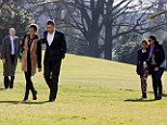 Protection: The first family of Barack and Michelle Obama, Sasha and Malia walk across the lawn of the White House guarded by Secret Service agents