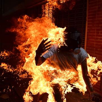 Image: A demonstrator catches fire during clashes with police 