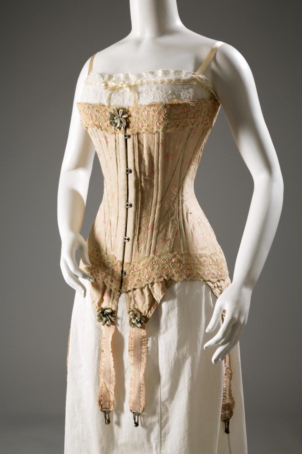 A Corset of floral brocaded silk, silk ribbon, and elastic, circa 1905, from England.